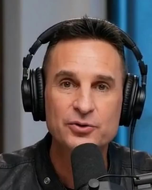 Greg Witz mid-sentence at a podcast microphone